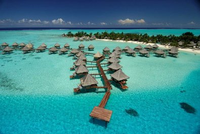 Huts-on-stilts over turquouise water